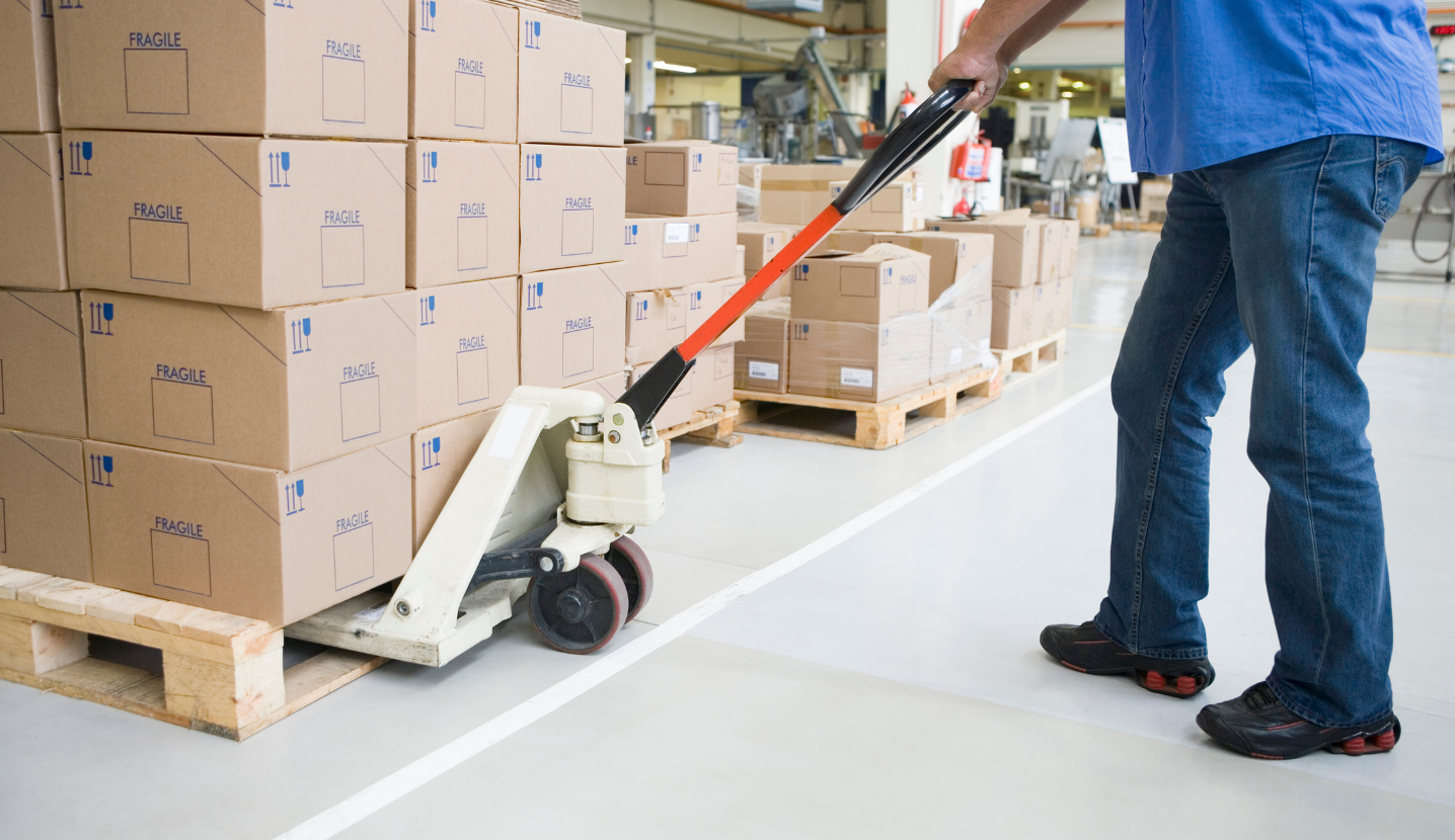 A person moves boxes in a warehouse